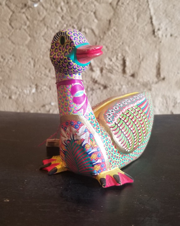 Carved colorful duck by Maria Jimenez Ojada